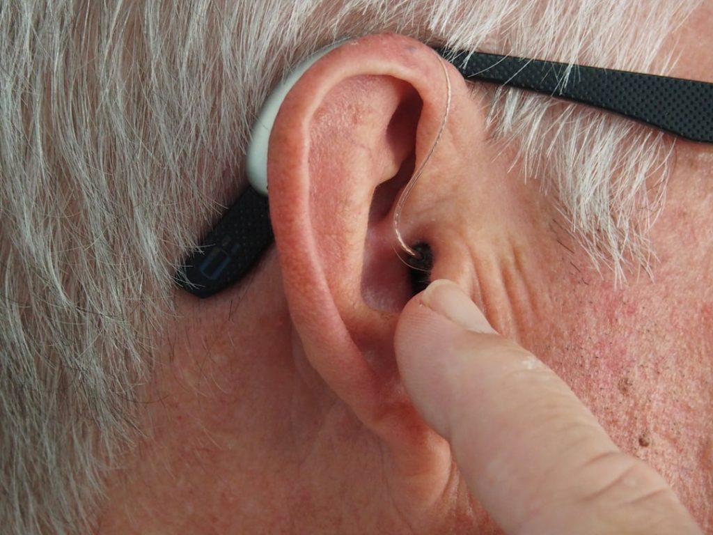 Close-up of modern hearing aid technology used during a workplace audiology consultation