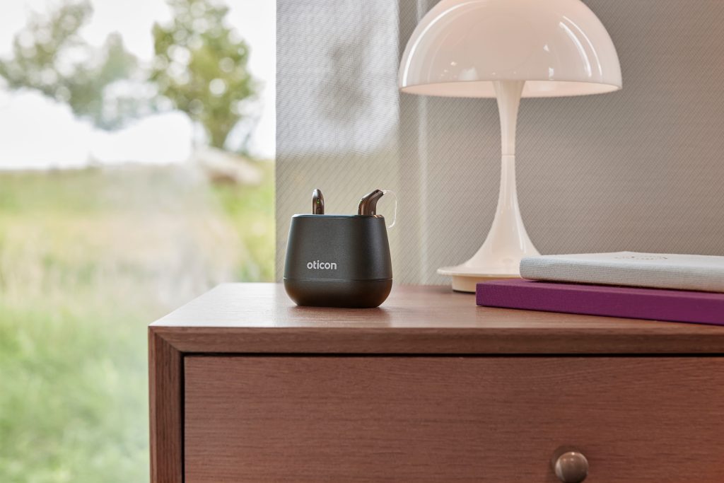 Oticon Intent charger on a bedside table