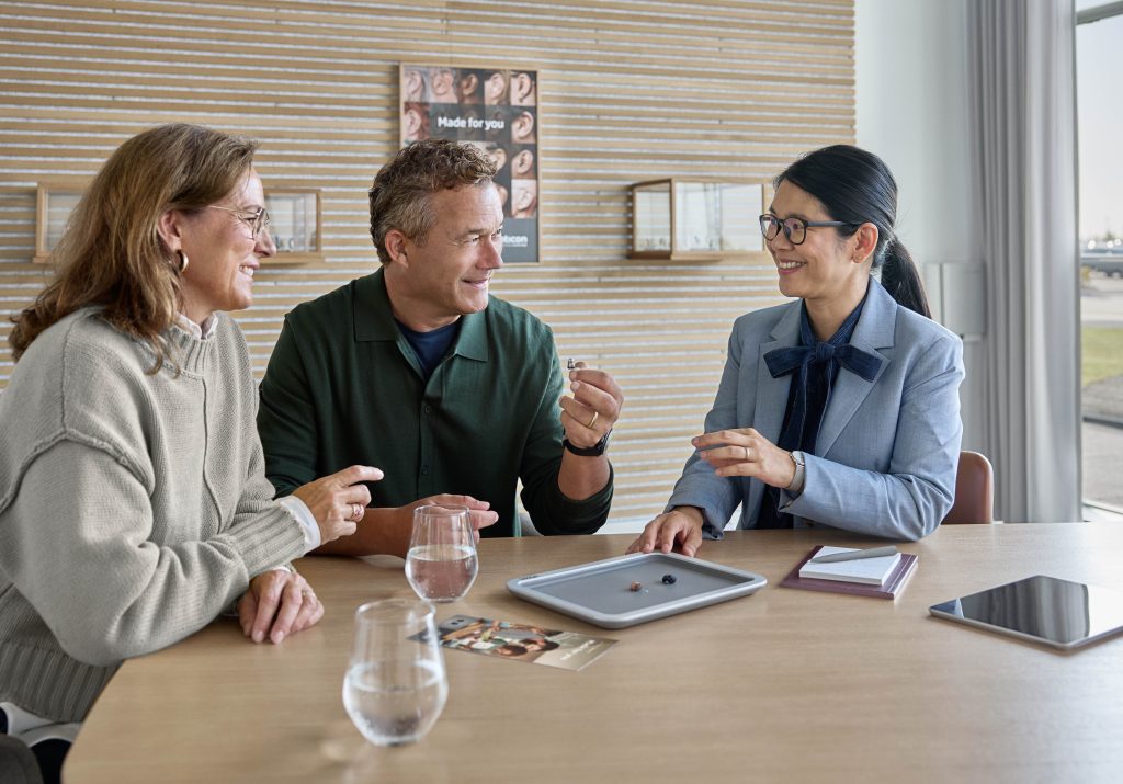Audiologist counselling a patient about custom Oticon hearing aids