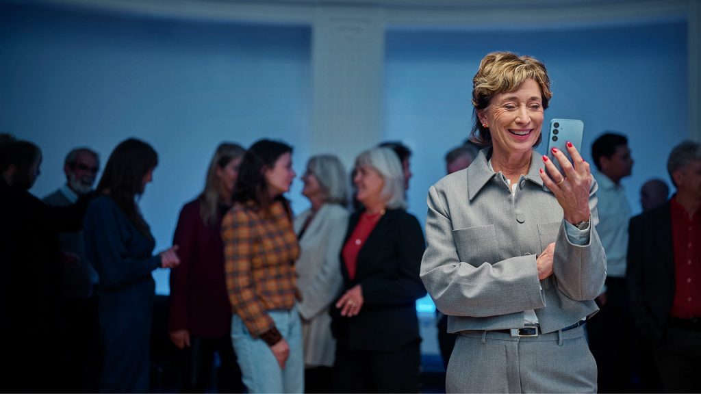 Woman using a smartphone in a busy environment illustrating Signia connectivity